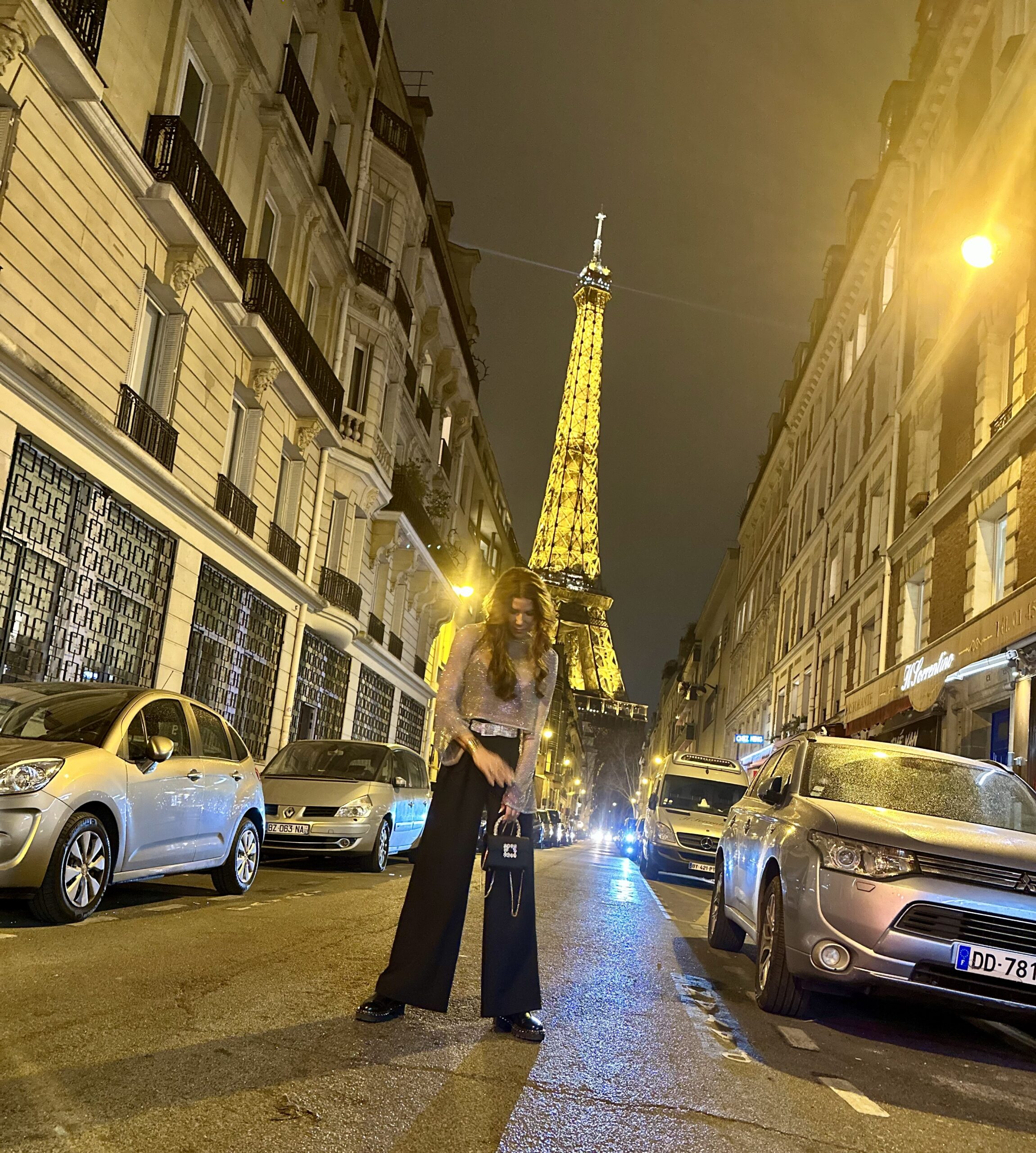 Paris itinerary for families, Teri in front of the Eifel tower at night